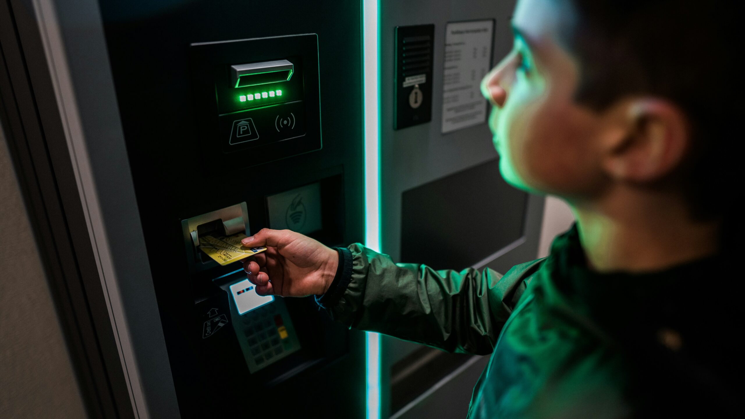 A man inserting a card into an ATM