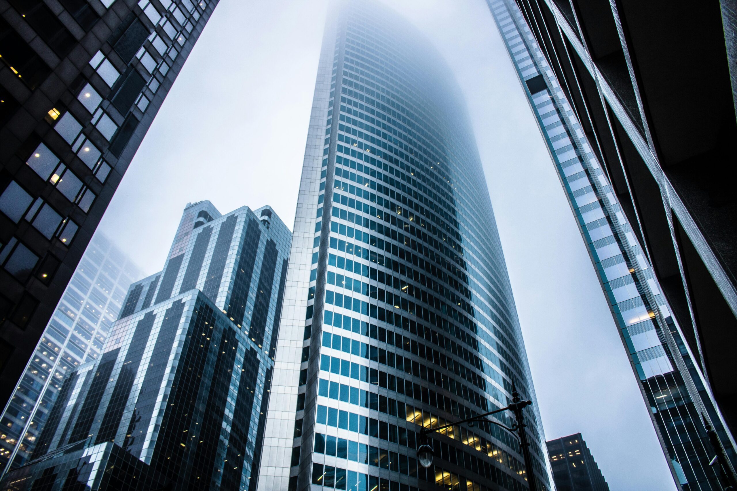 A photo of skyscrapers on a foggy day taken from ground level